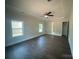 Bright bedroom featuring tray ceilings, a fan, and hardwood floors at 8605 Carly Ln, Mint Hill, NC 28227