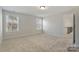 Bright and airy carpeted bedroom featuring two large windows at 8605 Carly Ln, Mint Hill, NC 28227