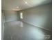 A large bedroom shows a window for natural light, and neutral paint at 8605 Carly Ln, Mint Hill, NC 28227