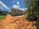 Two-story brick house with a covered patio offers serene privacy and ample space for enjoying the beautiful outdoor setting at 8605 Carly Ln, Mint Hill, NC 28227