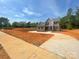 New construction home with inviting curb appeal and a freshly paved driveway at 8605 Carly Ln, Mint Hill, NC 28227