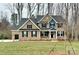 Two-story brick home featuring dark shutters, attached two car garage, and manicured front lawn at 8605 Carly Ln, Mint Hill, NC 28227