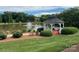 Scenic gazebo overlooking the lake with fountain and lush landscaping at 8605 Carly Ln, Mint Hill, NC 28227
