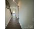Hallway with hardwood floors leading to the living room featuring a staircase at 8605 Carly Ln, Mint Hill, NC 28227
