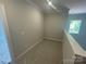 Bright hallway featuring neutral walls, white trim, and a window offering natural light at 8605 Carly Ln, Mint Hill, NC 28227