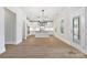 Open-concept kitchen with white cabinets, island, and contemporary lighting fixtures at 8605 Carly Ln, Mint Hill, NC 28227