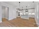 Modern kitchen with white cabinets, an island, and stainless steel appliances at 8605 Carly Ln, Mint Hill, NC 28227