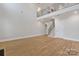 Large, light-filled living area featuring hardwood floors and staircase to the second level at 8605 Carly Ln, Mint Hill, NC 28227