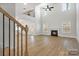 Bright, open living room with fireplace, hardwood floors, and two-story ceiling at 8605 Carly Ln, Mint Hill, NC 28227