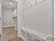 Organized mudroom with built-in bench and storage, adjacent to laundry area at 8605 Carly Ln, Mint Hill, NC 28227