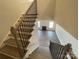 The staircase has wooden steps and black metal railings, leading to the main floor at 8605 Carly Ln, Mint Hill, NC 28227