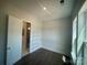 Spacious walk-in closet with dark wood floors and shelving installed at 8605 Carly Ln, Mint Hill, NC 28227