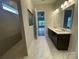 Bright bathroom features a double vanity, marble floors and a view to the bedroom beyond at 9411 Stonebridge Way # 49, Mint Hill, NC 28227