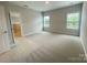 This bedroom is filled with natural light and features neutral walls, carpet, and a view of the outdoors at 9411 Stonebridge Way # 49, Mint Hill, NC 28227