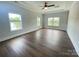 Bright bedroom with multiple windows overlooking a pond and wood-look floors at 9411 Stonebridge Way # 49, Mint Hill, NC 28227