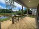 Spacious wooden deck overlooking a serene lake, ideal for relaxation at 9411 Stonebridge Way # 49, Mint Hill, NC 28227