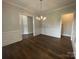 Formal dining room with wainscoting, hardwood floors, and chandelier at 9411 Stonebridge Way # 49, Mint Hill, NC 28227