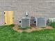 Exterior detail showing HVAC equipment next to brick wall and wood access door at 9411 Stonebridge Way # 49, Mint Hill, NC 28227