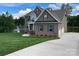 Charming brick home featuring a three-car garage and scenic lake views at 9411 Stonebridge Way # 49, Mint Hill, NC 28227