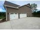 Exterior view of a home with a three-car garage and large driveway at 9411 Stonebridge Way # 49, Mint Hill, NC 28227