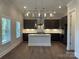 Stylish kitchen with an island, modern lighting, and stainless steel appliances at 9411 Stonebridge Way # 49, Mint Hill, NC 28227