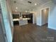 Modern kitchen features an island, stainless steel appliances, and stylish pendant lighting at 9411 Stonebridge Way # 49, Mint Hill, NC 28227