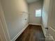 Small laundry room with a wire shelf, a window, and wood-look flooring at 9411 Stonebridge Way # 49, Mint Hill, NC 28227