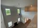 An upstairs view of the living room with fireplace and backyard views at 9411 Stonebridge Way # 49, Mint Hill, NC 28227