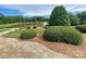 Landscaped greenery surrounds a pond with a fountain, creating a serene outdoor space at 9411 Stonebridge Way # 49, Mint Hill, NC 28227