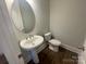 Cozy powder room with pedestal sink and modern toilet at 9411 Stonebridge Way # 49, Mint Hill, NC 28227