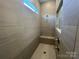 The tiled shower features a window, bench and modern shower fixtures at 9411 Stonebridge Way # 49, Mint Hill, NC 28227