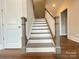 A view of the stairway with contemporary gray and white design at 9411 Stonebridge Way # 49, Mint Hill, NC 28227
