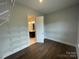 A walk-in closet with built-in shelving and a view to the bright bathroom at 9411 Stonebridge Way # 49, Mint Hill, NC 28227