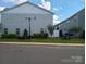 Rear view of townhome showing gray siding and small fenced yard at 13969 Clayborn St, Midland, NC 28107