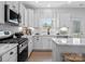 Bright kitchen with white cabinetry, stainless steel appliances, marble countertops, and a gas range at 136 Ella Claire Dr, York, SC 29745