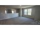 Open bonus room space with neutral carpet, ample natural light, and versatile layout for various uses at 143 Ella Claire Dr, York, SC 29745