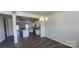 Bright and airy open-concept kitchen featuring stainless steel appliances, an island, and dark hardwood floors at 143 Ella Claire Dr, York, SC 29745