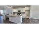 Well-equipped kitchen boasts granite countertops, stainless steel appliances, an island, and modern gray backsplash at 143 Ella Claire Dr, York, SC 29745