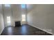 Inviting living room showcasing a soaring ceiling, gas fireplace, and an abundance of natural light from large windows at 143 Ella Claire Dr, York, SC 29745