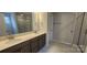 Modern bathroom with double sinks, quartz countertops, sleek cabinetry, and a glass-enclosed shower at 169 Ella Claire Dr, York, SC 29745