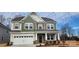 A beautiful two-story home with a two-car garage, stone accents, and a covered front porch at 169 Ella Claire Dr, York, SC 29745