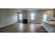 Bright living room featuring hardwood floors, a fireplace, and large windows for natural light at 169 Ella Claire Dr, York, SC 29745