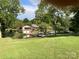 Expansive backyard featuring waterfront access, boat dock, and lush green lawn at 24756 Strand Dr, Albemarle, NC 28001
