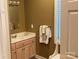 Cozy bathroom featuring a neutral color scheme, vanity with storage, and a private seated area next to the window at 24756 Strand Dr, Albemarle, NC 28001