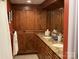 Bathroom featuring dual sinks, granite countertops, and warm, wood cabinets and drawers at 24756 Strand Dr, Albemarle, NC 28001