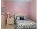 Comfortable bedroom with a decorative headboard, coordinated bedding, and a nightstand with a lamp at 24756 Strand Dr, Albemarle, NC 28001