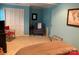 Spacious bedroom with blue walls, comfortable seating, and neutral carpet at 24756 Strand Dr, Albemarle, NC 28001