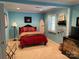 Stylish bedroom featuring blue walls and maritime-themed decor, creating a tranquil atmosphere at 24756 Strand Dr, Albemarle, NC 28001