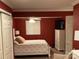This bedroom features a ceiling fan, double closet, red walls and crisp white trim at 24756 Strand Dr, Albemarle, NC 28001