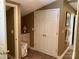 Hallway with a double-door closet, access to adjacent rooms, and a utility cabinet at 24756 Strand Dr, Albemarle, NC 28001